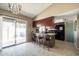 Eat-in kitchen with a breakfast bar, black appliances, and sliding glass doors to the patio at 17802 N 45Th Ave, Glendale, AZ 85308