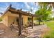 Charming backyard featuring a pergola covered patio, swing, and meticulously maintained landscaping at 17804 N Del Webb Blvd, Sun City, AZ 85373