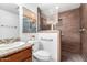 Bathroom featuring a granite countertop, decorative wall art, and a tiled shower at 17804 N Del Webb Blvd, Sun City, AZ 85373