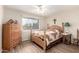 Bedroom featuring a wooden bed frame, wood floors, and natural light at 17804 N Del Webb Blvd, Sun City, AZ 85373