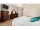 Bedroom featuring a ceiling fan, TV, light walls, and a dresser at 17804 N Del Webb Blvd, Sun City, AZ 85373
