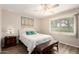 Bright bedroom showcasing ceiling fan, a large window, and neutral decor at 17804 N Del Webb Blvd, Sun City, AZ 85373