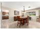 The dining room features tile floors, a wood dining table, and a view into the kitchen area at 17804 N Del Webb Blvd, Sun City, AZ 85373