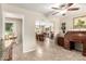 Open-concept living space seamlessly connecting to the dining area; tiled flooring at 17804 N Del Webb Blvd, Sun City, AZ 85373