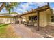 Spacious pergola-covered patio with brick pavers, swing, and outdoor seating for entertaining at 17804 N Del Webb Blvd, Sun City, AZ 85373