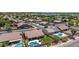 A beautiful home features a refreshing freeform pool, desert landscaping, and a well-manicured green lawn at 17836 N 52Nd Pl, Scottsdale, AZ 85254