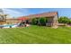 Expansive backyard with lush green grass, landscaping, and a view of the covered patio at 17836 N 52Nd Pl, Scottsdale, AZ 85254