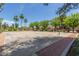 Community basketball court, lined by mature trees and palm trees under a blue sky at 17836 N 52Nd Pl, Scottsdale, AZ 85254
