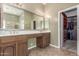 Bathroom with double sinks, cabinets, and a view into the walk-in closet at 17836 N 52Nd Pl, Scottsdale, AZ 85254