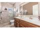 Beautiful bathroom featuring double sinks, a large mirror, and a tiled walk-in shower at 17836 N 52Nd Pl, Scottsdale, AZ 85254