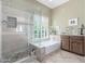 Gorgeous bathroom featuring a large walk-in shower, bathtub, and a large bright window at 17836 N 52Nd Pl, Scottsdale, AZ 85254