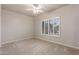 Well-lit bedroom featuring carpet, a ceiling fan, and a window with shutters at 17836 N 52Nd Pl, Scottsdale, AZ 85254