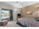 Bedroom with patio access overlooking the pool, a ceiling fan, and a large window at 17836 N 52Nd Pl, Scottsdale, AZ 85254