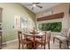 Charming dining area with wooden table, natural light, and views of the outdoor greenery, ideal for Gathering meals at 17836 N 52Nd Pl, Scottsdale, AZ 85254