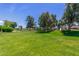 Expansive community green space with mature trees and a playground at 17836 N 52Nd Pl, Scottsdale, AZ 85254