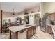 Expansive kitchen island with double sink and bar seating with an open design to the living spaces at 17836 N 52Nd Pl, Scottsdale, AZ 85254