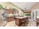 Spacious kitchen with stainless steel appliances, a large island with seating, and ample cabinet space for storage at 17836 N 52Nd Pl, Scottsdale, AZ 85254