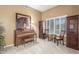 Cozy living room featuring a piano, artwork, and cabinets offering ample storage at 17836 N 52Nd Pl, Scottsdale, AZ 85254