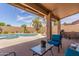 Inviting patio with comfortable seating and a view of the sparkling pool and lush landscaping at 17836 N 52Nd Pl, Scottsdale, AZ 85254