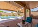 Covered patio offers a relaxing space overlooking the pool and landscaped backyard at 17836 N 52Nd Pl, Scottsdale, AZ 85254