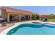 Pool area with covered patio, BBQ, landscaping, and lounge chairs under a red umbrella at 17836 N 52Nd Pl, Scottsdale, AZ 85254