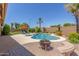 Backyard pool area featuring a fire pit, desert landscaping, lounge chairs, and a spa at 17836 N 52Nd Pl, Scottsdale, AZ 85254