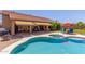 View of the pool and covered patio with landscaping and lounge chairs in the backyard at 17836 N 52Nd Pl, Scottsdale, AZ 85254