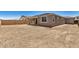 The backyard features a partially covered patio area, dirt landscaping, and a block fence at 18210 W Hess St, Goodyear, AZ 85338