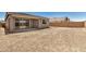 The backyard features a partially covered patio area, dirt landscaping, and a block fence at 18210 W Hess St, Goodyear, AZ 85338