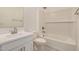 Bathroom featuring a shower-over-tub setup and modern vanity with neutral color palette at 18210 W Hess St, Goodyear, AZ 85338