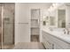 Bright bathroom with double sinks, modern fixtures, and glass shower door at 18210 W Hess St, Goodyear, AZ 85338