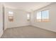 Neutral bedroom featuring carpeted floors, white walls, recessed lighting, and windows with views at 18210 W Hess St, Goodyear, AZ 85338