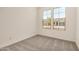 Bedroom with carpet and a window that offers natural lighting and neighborhood views at 18210 W Hess St, Goodyear, AZ 85338