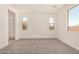 Cozy bedroom featuring carpeted floors, white walls, recessed lighting, windows, and closet space at 18210 W Hess St, Goodyear, AZ 85338