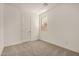 Clean and carpeted bedroom with a window and a view outside at 18210 W Hess St, Goodyear, AZ 85338