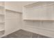 Walk-in closet with carpet, white walls and shelving for optimal storage at 18210 W Hess St, Goodyear, AZ 85338