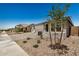 Charming single-story home with desert landscaping, and a driveway at 18210 W Hess St, Goodyear, AZ 85338