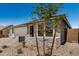 Charming single-story home with desert landscaping, and a driveway at 18210 W Hess St, Goodyear, AZ 85338