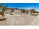 Spacious three-car garage with decorative stone accents and a large paved driveway at 18210 W Hess St, Goodyear, AZ 85338