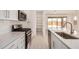 Bright kitchen features stainless appliances, white cabinetry, subway tile backsplash and outdoor views at 18210 W Hess St, Goodyear, AZ 85338