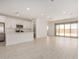 Spacious living room featuring light tile floors, recessed lighting, white walls and an open floor plan at 18210 W Hess St, Goodyear, AZ 85338