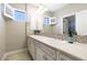 Bathroom featuring double sinks, mosaic backsplash, and neutral color palette at 18515 N 97Th Way, Scottsdale, AZ 85255