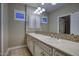Bathroom showcasing dual sinks with granite countertops, decorative mirrors, and natural lighting at 18515 N 97Th Way, Scottsdale, AZ 85255