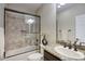 Bathroom featuring a granite sink and a shower-tub combo with tile surround at 18515 N 97Th Way, Scottsdale, AZ 85255