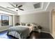 Bedroom featuring a ceiling fan, neutral walls, and dark wood floors at 18515 N 97Th Way, Scottsdale, AZ 85255
