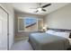 Bright bedroom featuring a ceiling fan, a closet, and plantation shutters at 18515 N 97Th Way, Scottsdale, AZ 85255