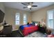 Cozy bedroom with playful decor, ceiling fan, large windows, and plush carpeting at 18515 N 97Th Way, Scottsdale, AZ 85255