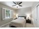 Bedroom featuring a queen size bed, ceiling fan, and window with shutters at 18515 N 97Th Way, Scottsdale, AZ 85255