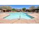 Sparkling community pool featuring tanning shelves, a hot tub, and ample seating at 18515 N 97Th Way, Scottsdale, AZ 85255
