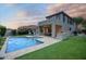 Exterior view of backyard showcasing a swimming pool, patio, and well-manicured lawn at 18515 N 97Th Way, Scottsdale, AZ 85255